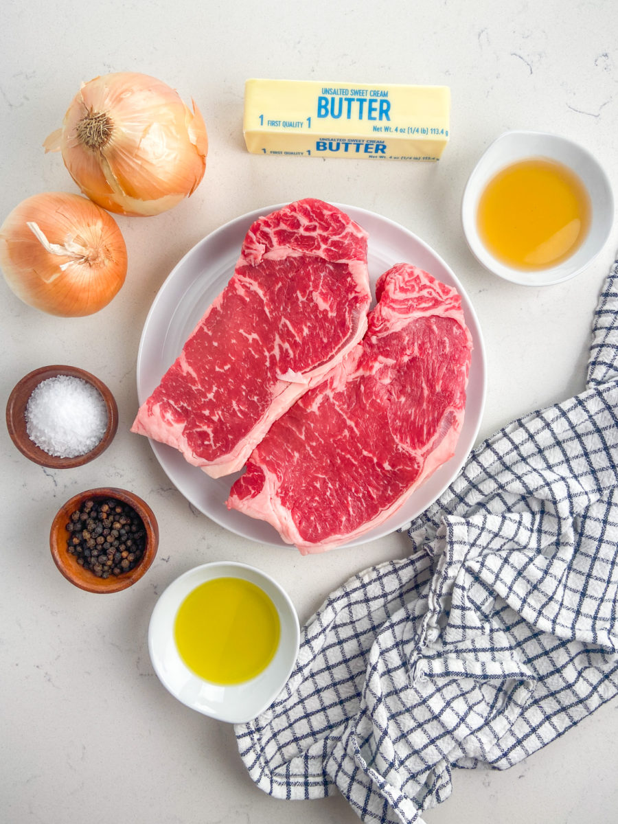 Steak with bourbon onions ingredients on white background. 