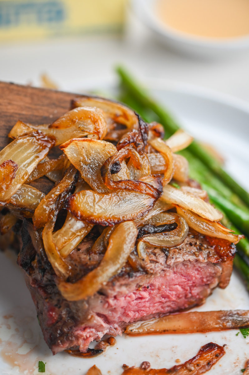 Steak with Bourbon Caramelized Onions on top. 