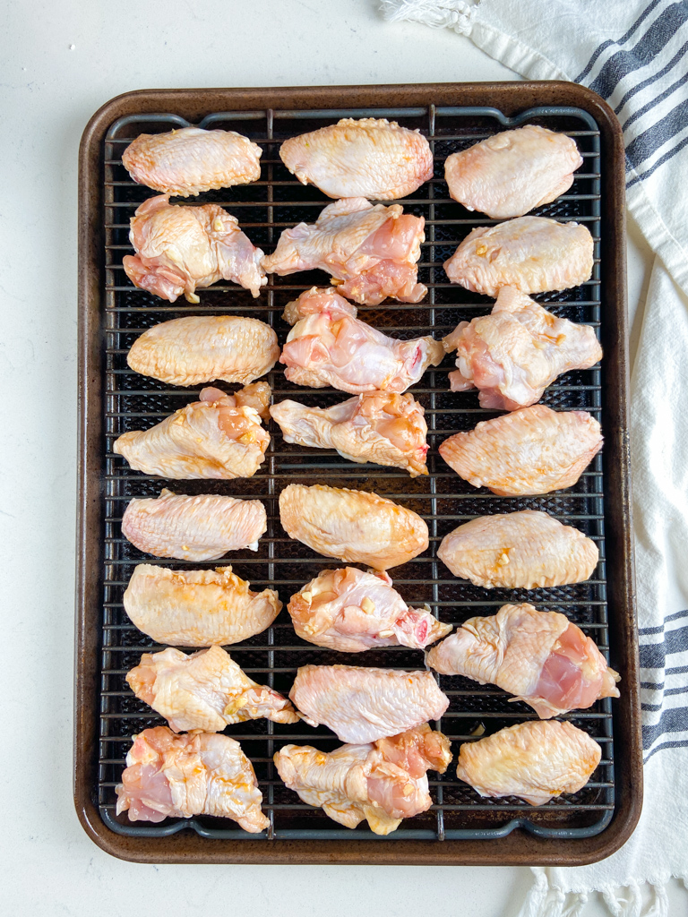 Overhead photo of sweet chili chicken wings on a baking sheet.