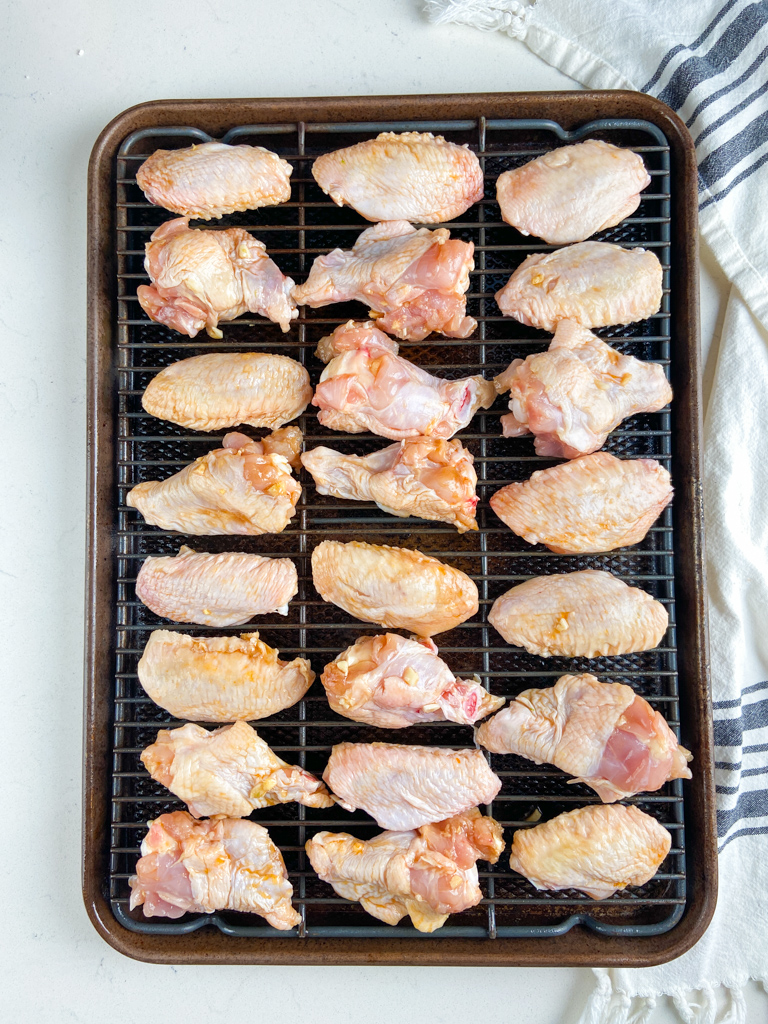 Overhead photo of sweet chili chicken wings on a baking sheet. 