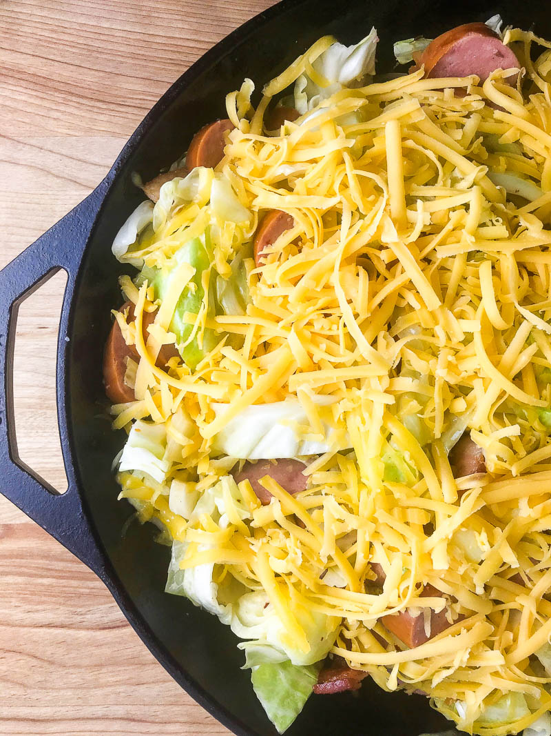 Kielbasa and Cabbage Tater Tot Casserole is comfort food of epic proportions. Sautéed cabbage and kielbasa topped with cheddar cheese and tater tots, then baked until crisp. 