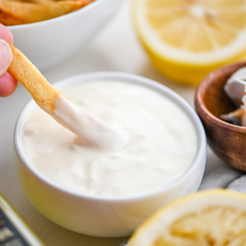 French fry dipping in Truffle Aioli.