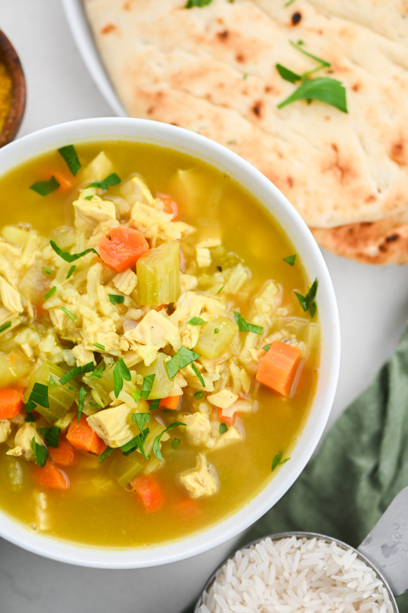 Turkey curry soup in white bowl. 