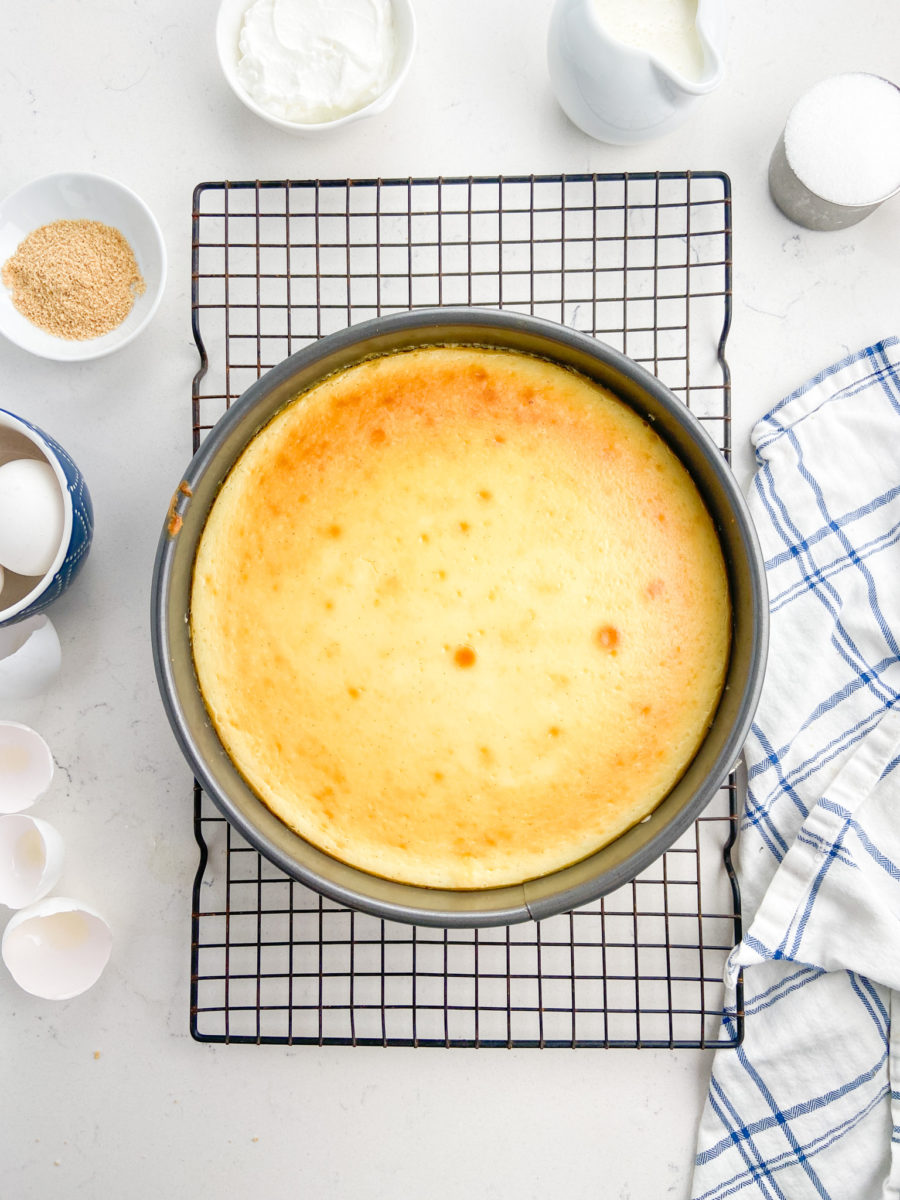 Vanilla Bean Cheesecake cooling on wire rack. 