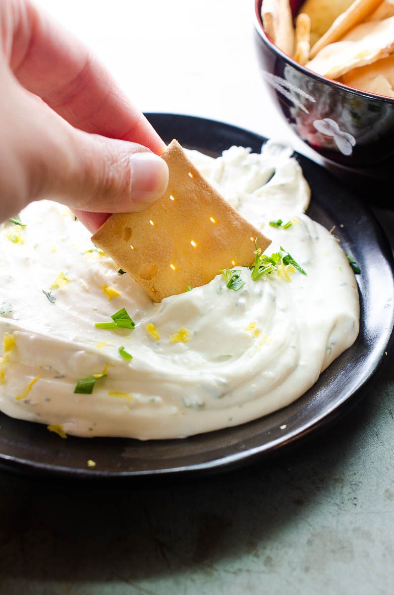 Cracker dipping in whipped feta 