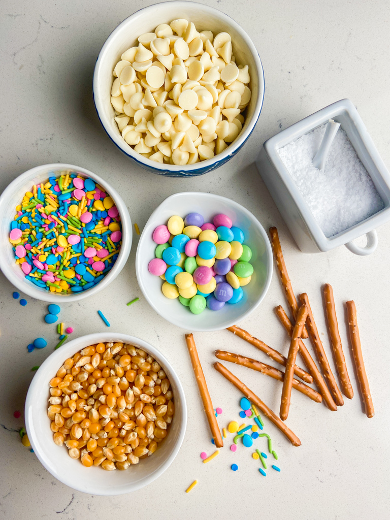 Overhead photo of ingredients needed to make white chocolate popcorn. 