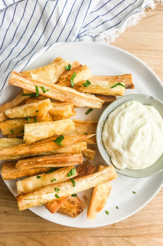 Yuca fries on a plate with aioli dipping sauce