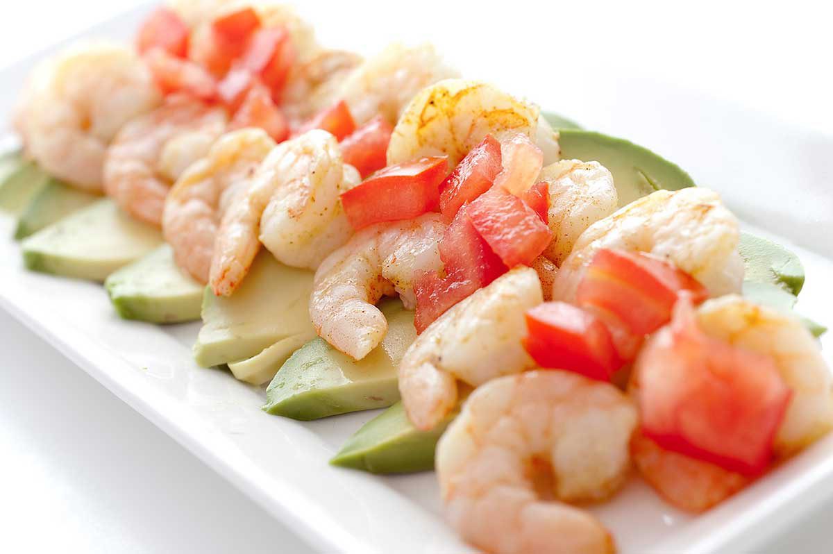 Adobo Shrimp on a bed of sliced avocado, topped with tomatoes and a squirt of lime. Quick, easy and a reminder that summer is just around the corner. 