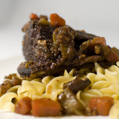 Braised short rib on noodles.