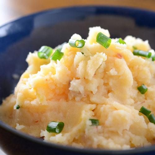 Chipotle cheddar mashed potatoes in blue bowl.