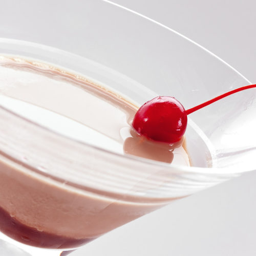 close up of chocolate covered martini with cherry
