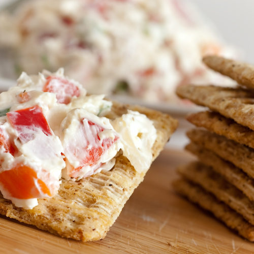 Creamy vegetable dip on wheat crackers