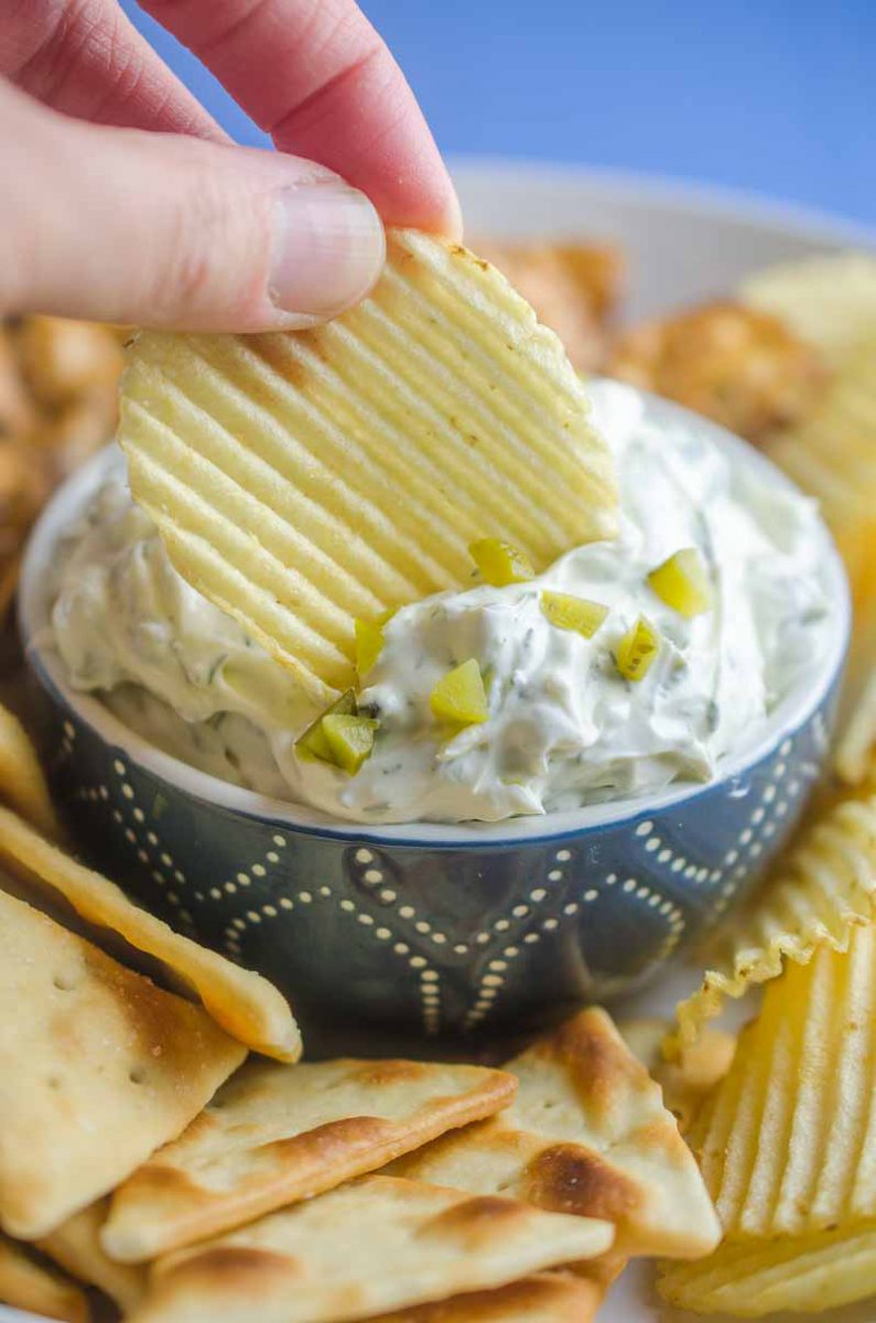 Creamy Dill Pickle Dip is going to be THE dip you'll want to bring to all your summer potlucks. It is super easy to make and a crowd pleaser! 