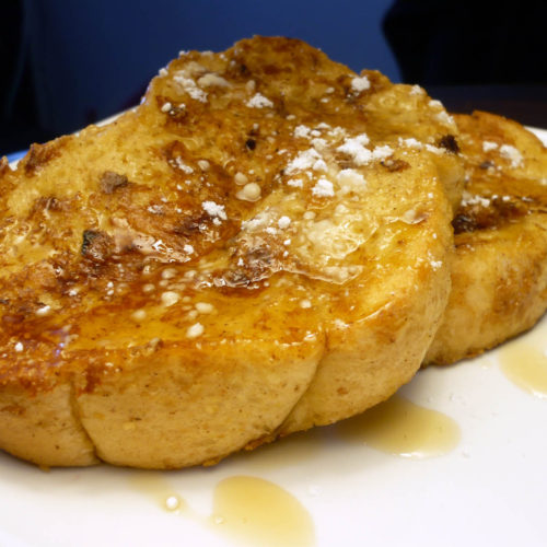 Eggnog french toast on white plate.