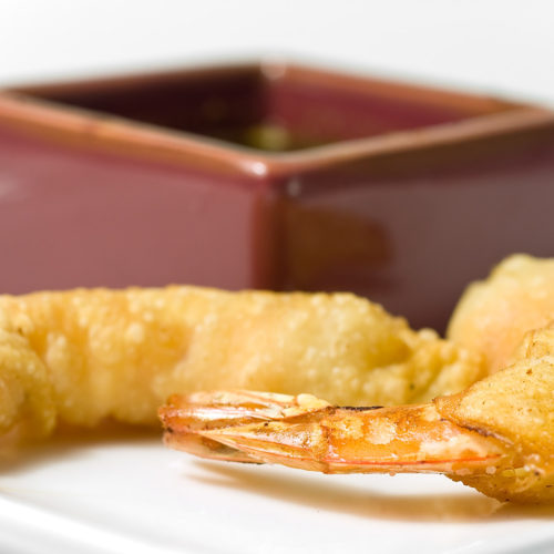 firecracker prawns on white plate