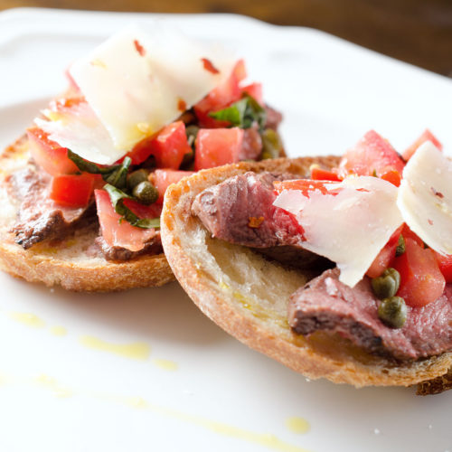 Steak bruschetta on plate.