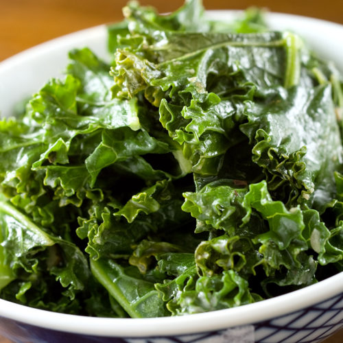 Sauteed kale with tahini in white bowl.