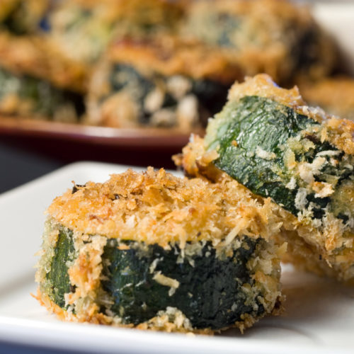 sliced zucchini stuffed with mozzarella on white plate.