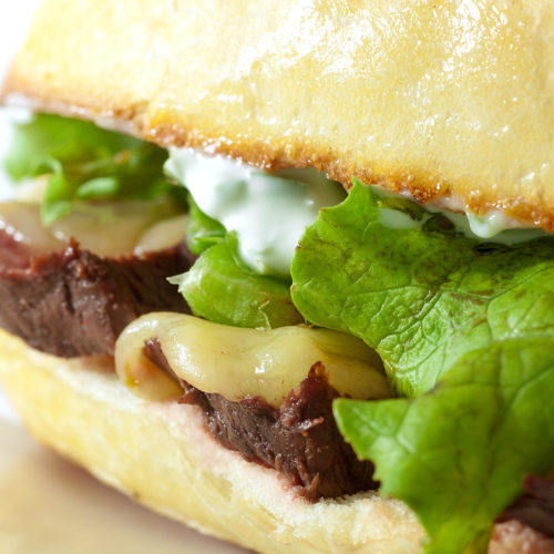 Close up of pepper jack steak sandwich.