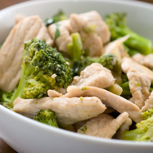 Pork and broccoli stir fry white bowl.