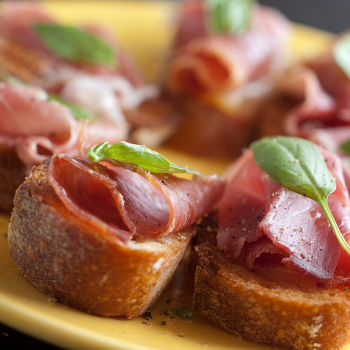 Prosciutto and basil crostini