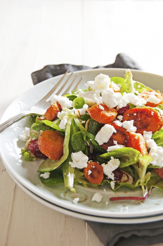 Say hello to the fall with this roasted carrot salad, featuring a balsamic vinaigrette, greens, and crumbled goat cheese.