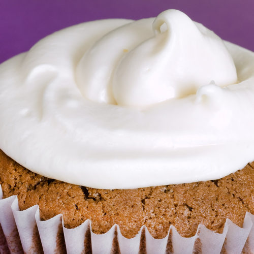 close up of rolo cupcake with purple background.