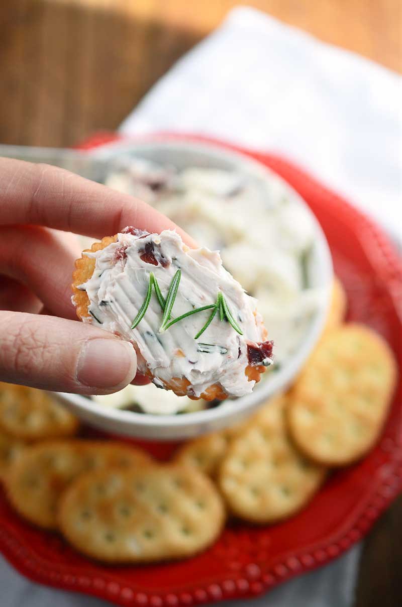 This easy, festive Rosemary and Cranberry Spread will be the hit of all of your holiday parties!