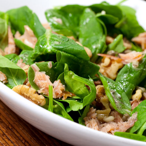 Close up of smoked salmon salad in white bowl