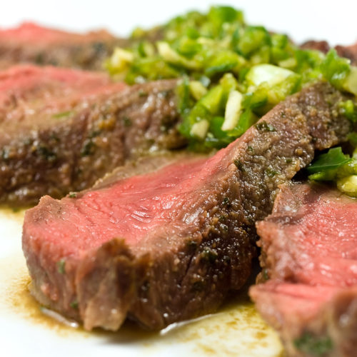 Sliced steak with chili lime sauce.