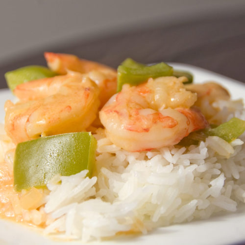Thai Red Prawn Curry on white plate with rice.