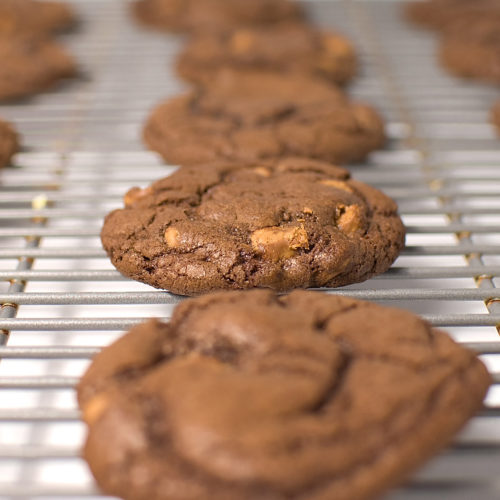 triple chocolate peanut butter cookies on wire rack.