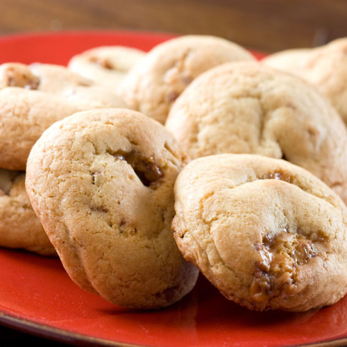 Twix cookies on red plate.