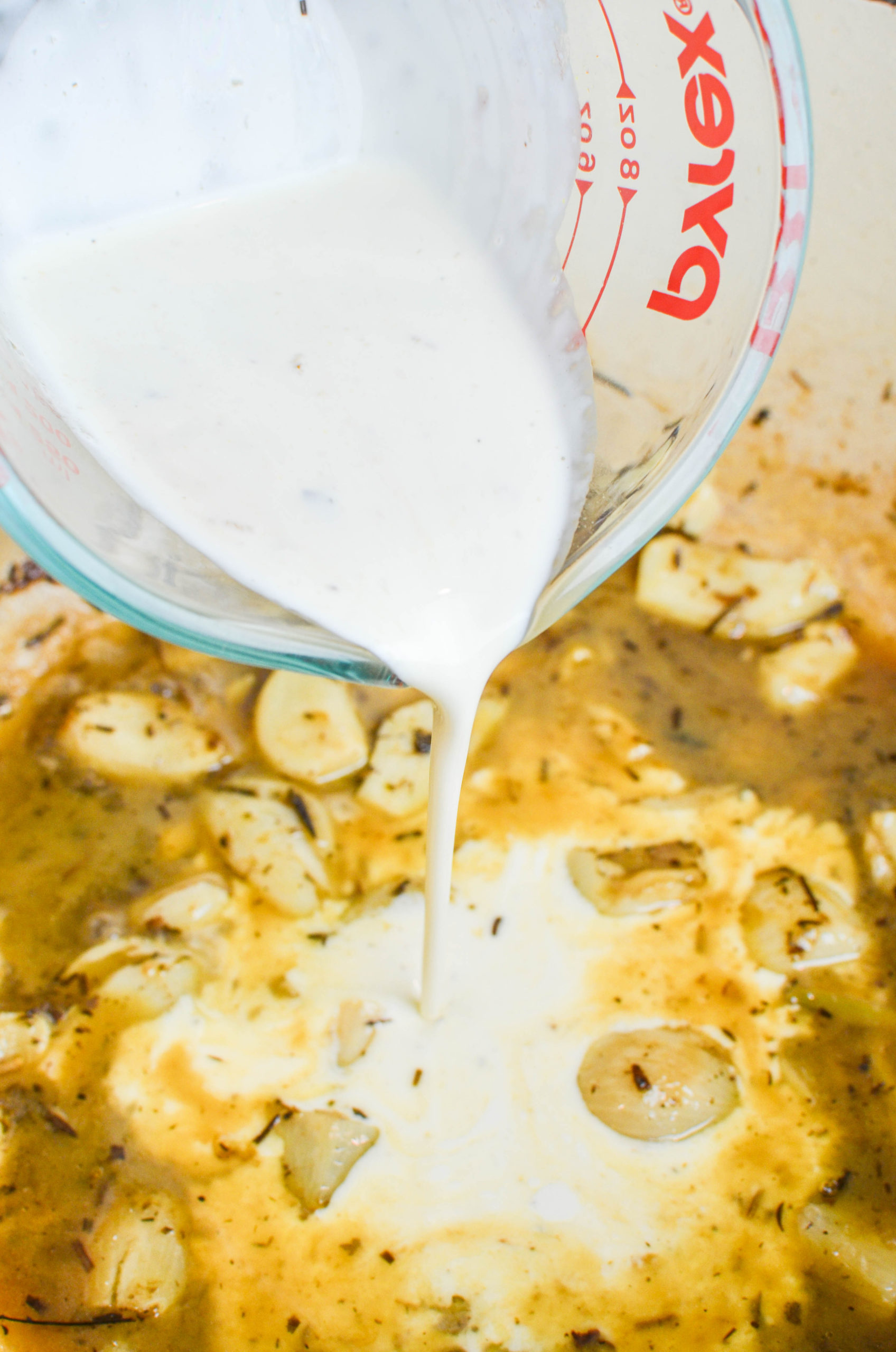 Pouring cream into sauce. 