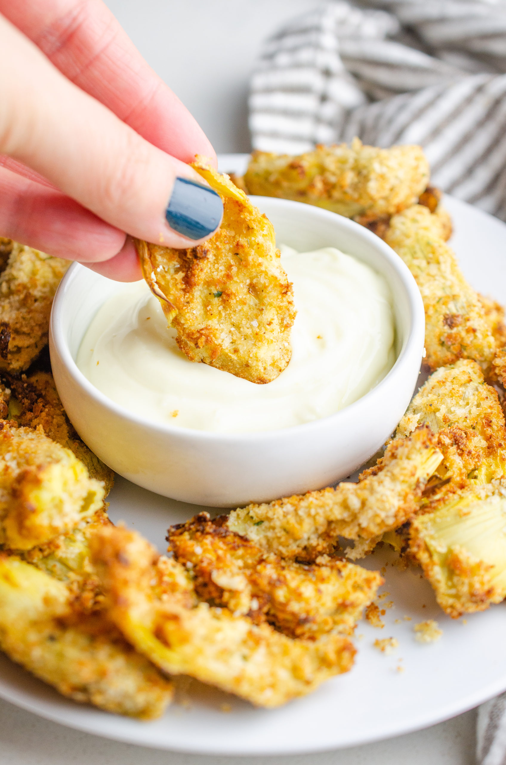 Dipping an air fried artichoke in garlic aioli. 