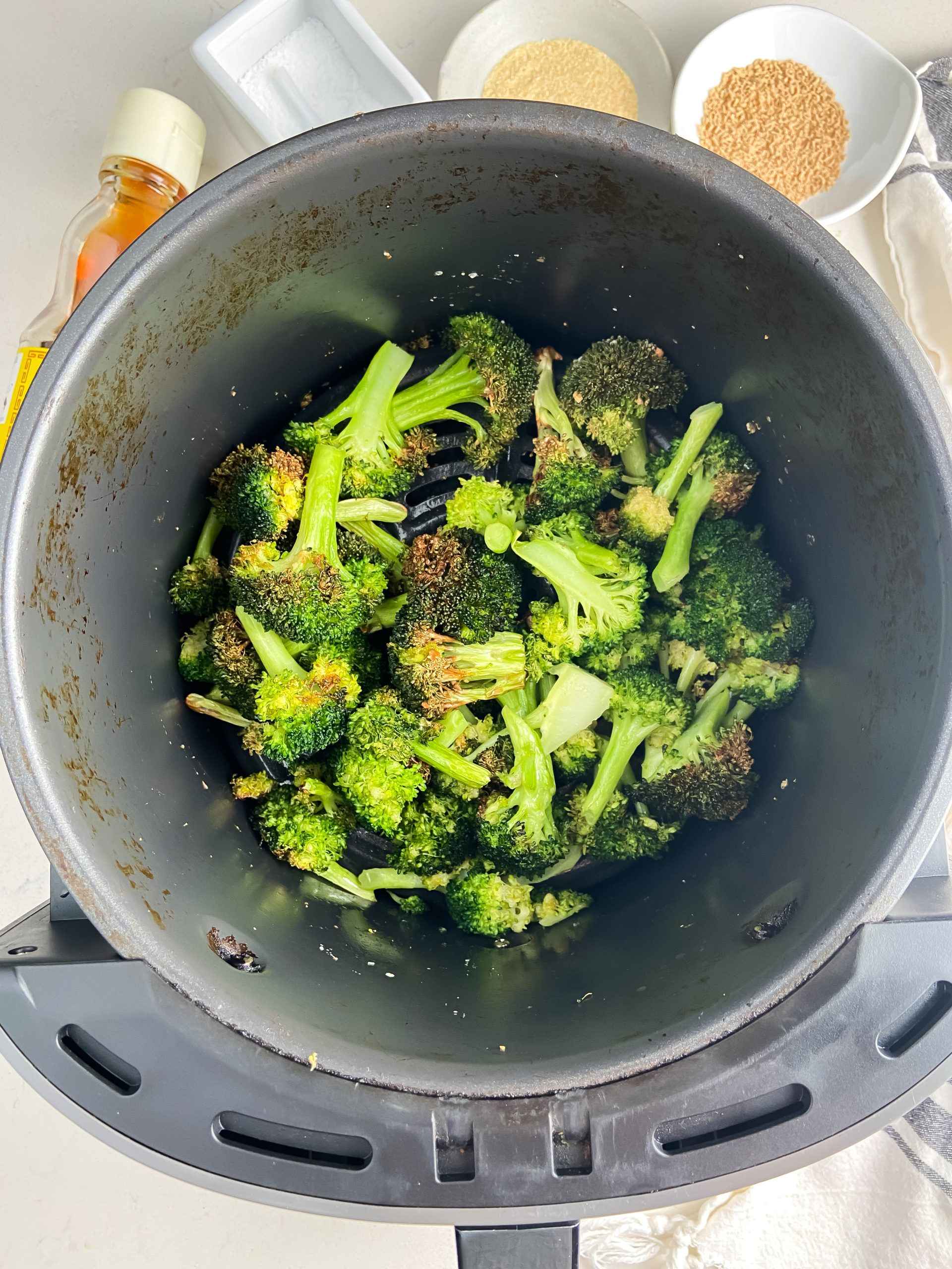 Overhead photo of broccoli in an air fryer. 