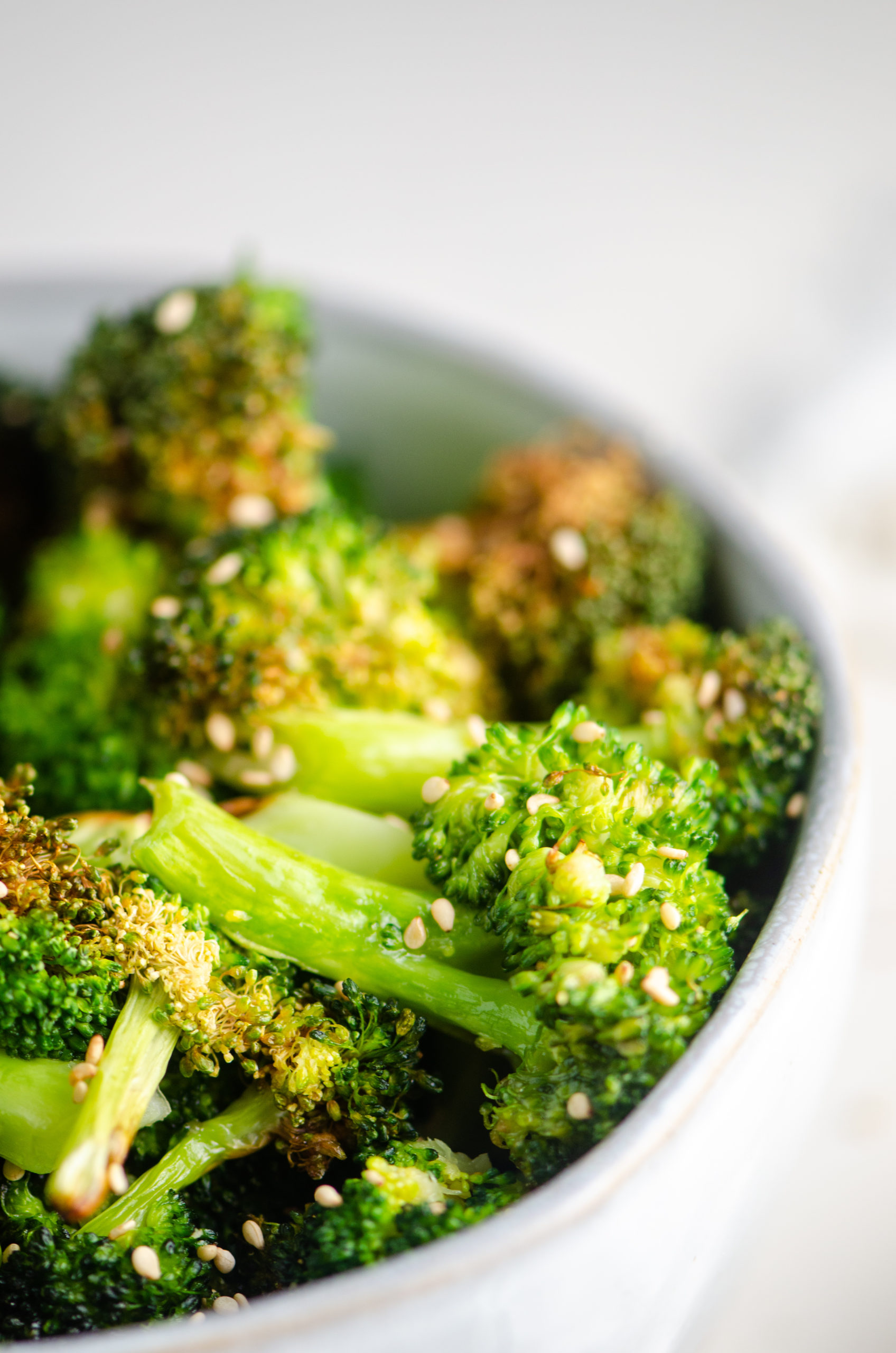 Close up side shot of air fryer broccoli in a bowl. 