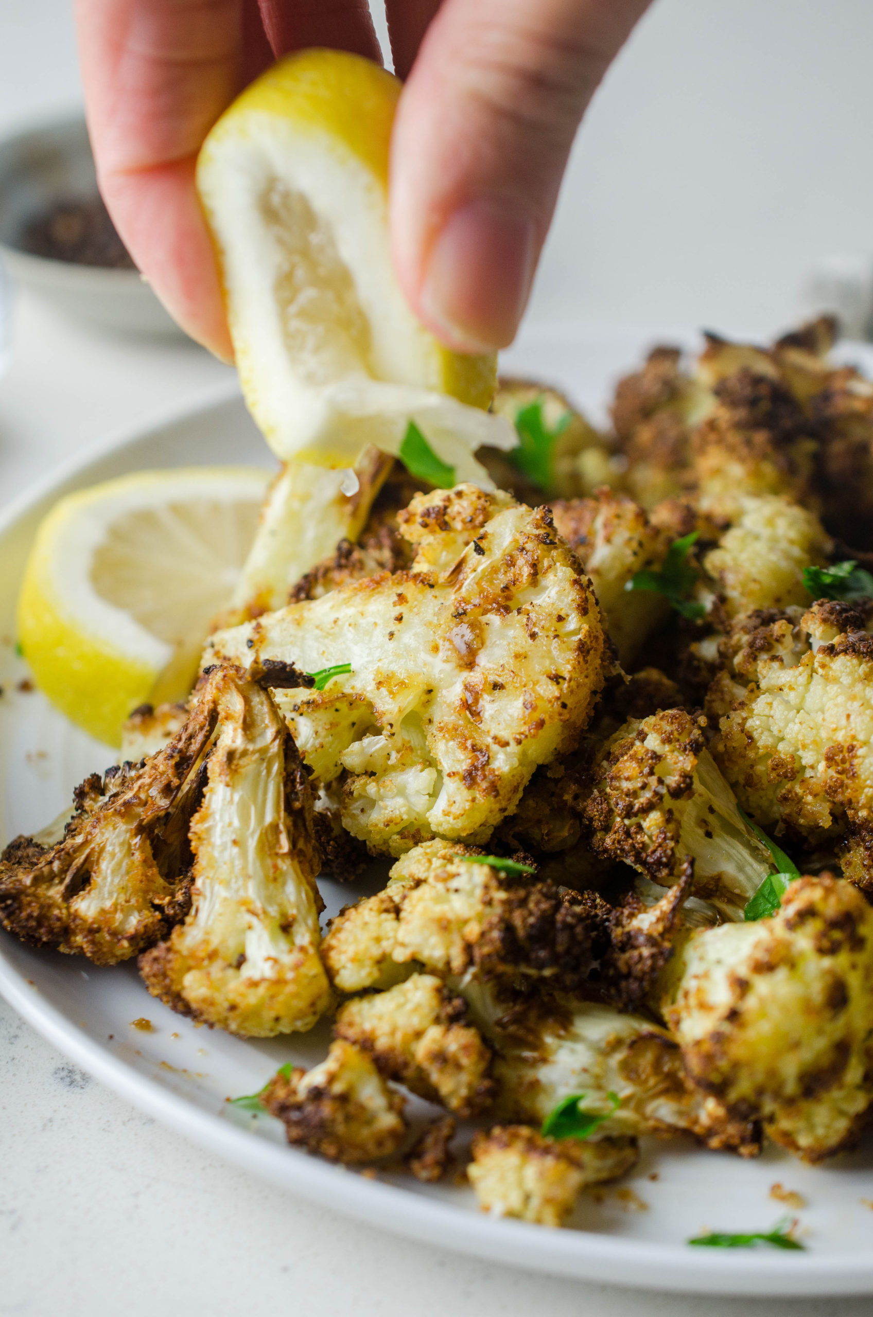 Squeezing lemon on air fried cauliflower