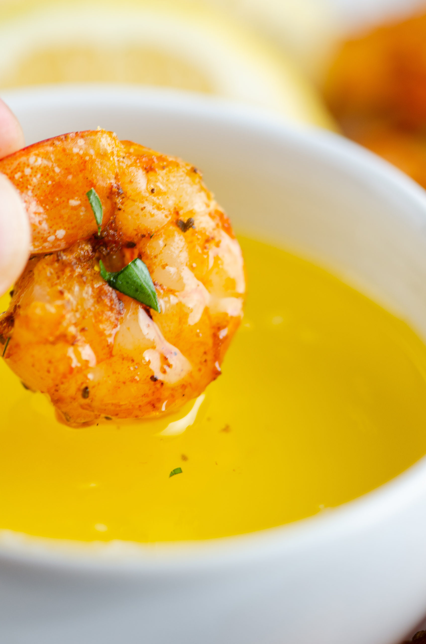 Dipping air fryer fried shrimp in butter. 