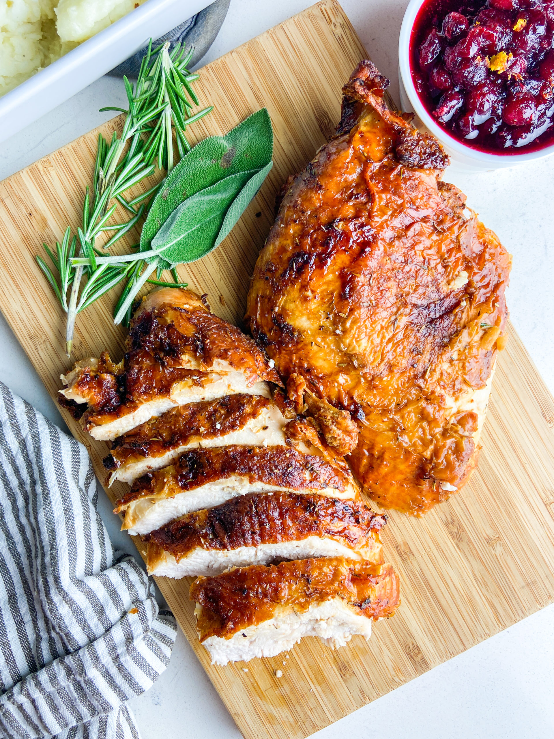 Overhead photo of air fryer turkey breast on wooden cutting board. 