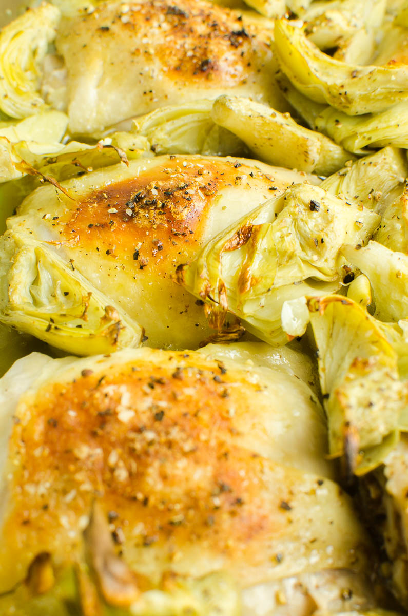 Chicken and artichokes in a baking dish. 