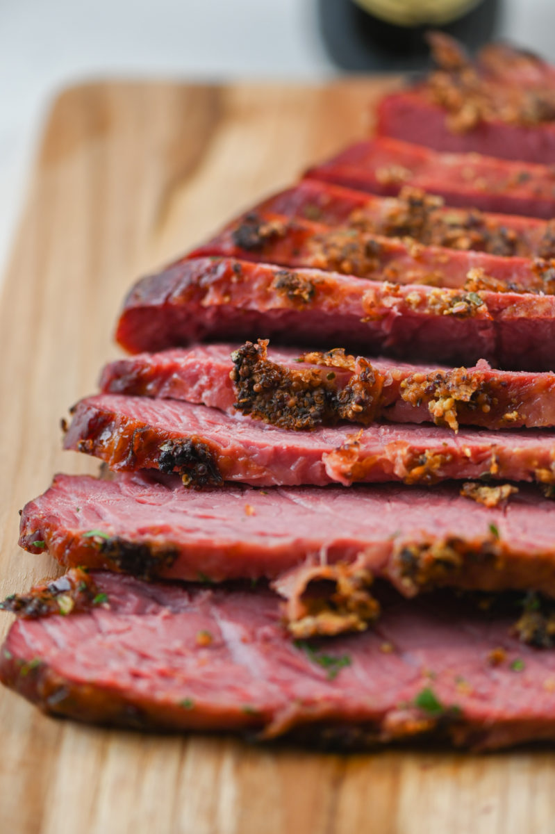 Sliced corned beef on cutting board. 