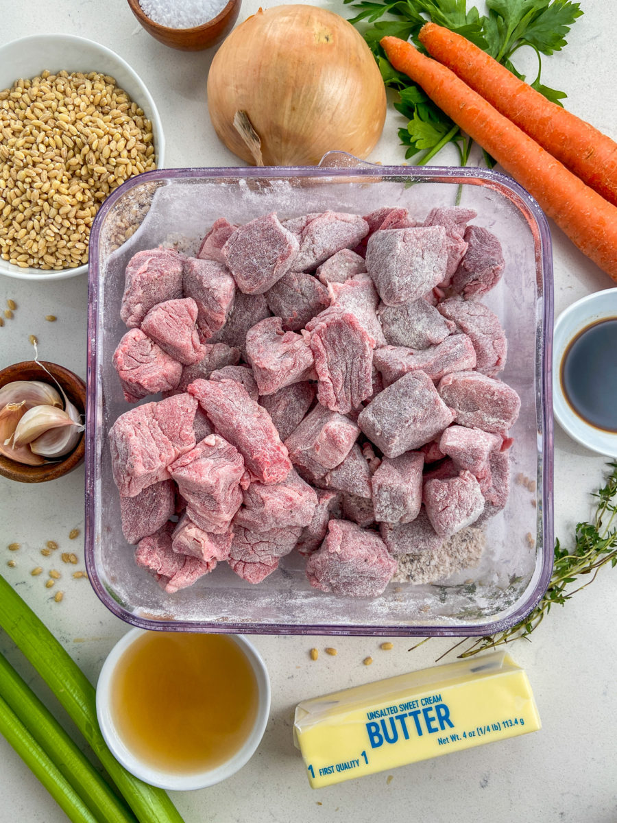 Chuck roast pieces coated in flour. 