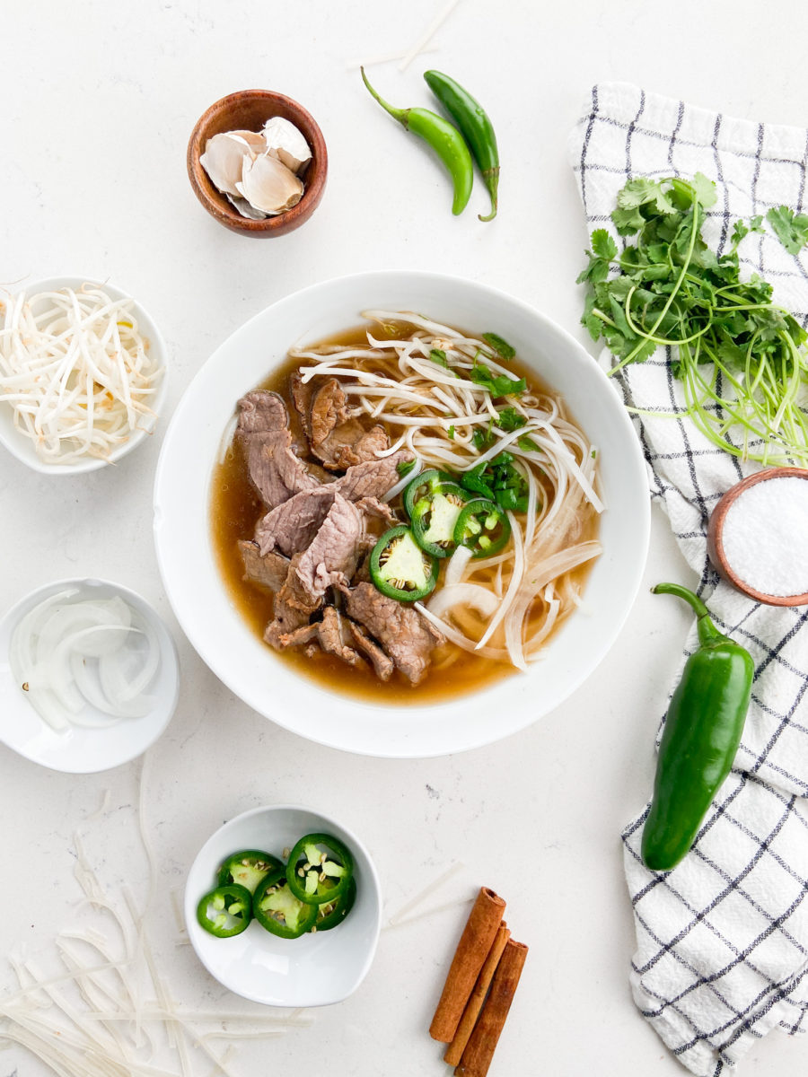 Beef noodle soup in white bowl. 