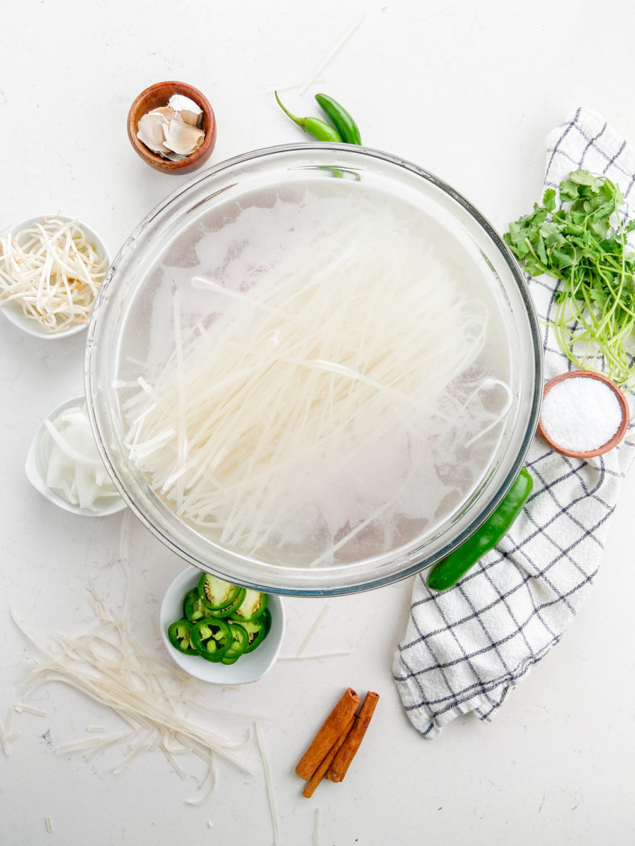Rice noodles in water in a glass bowl. 