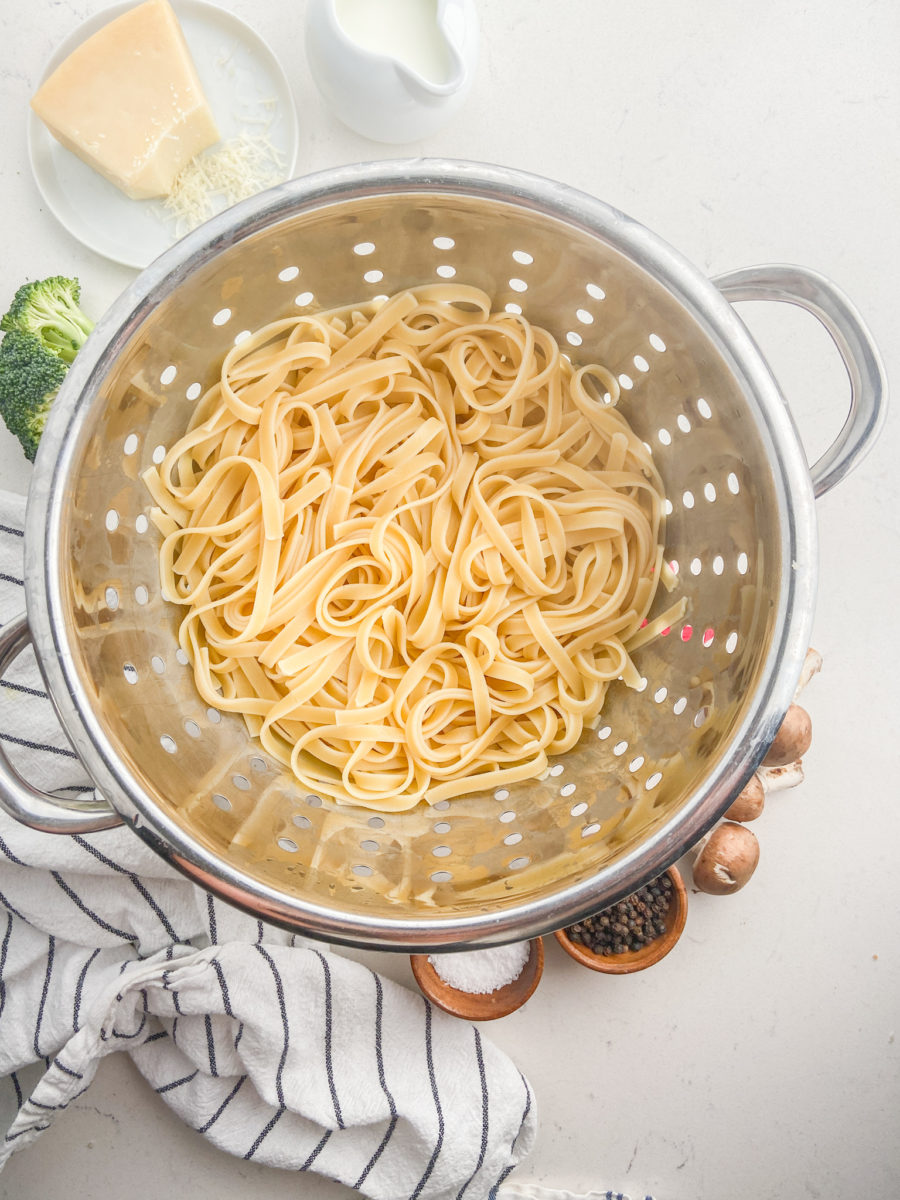 Cooked pasta in colander. 