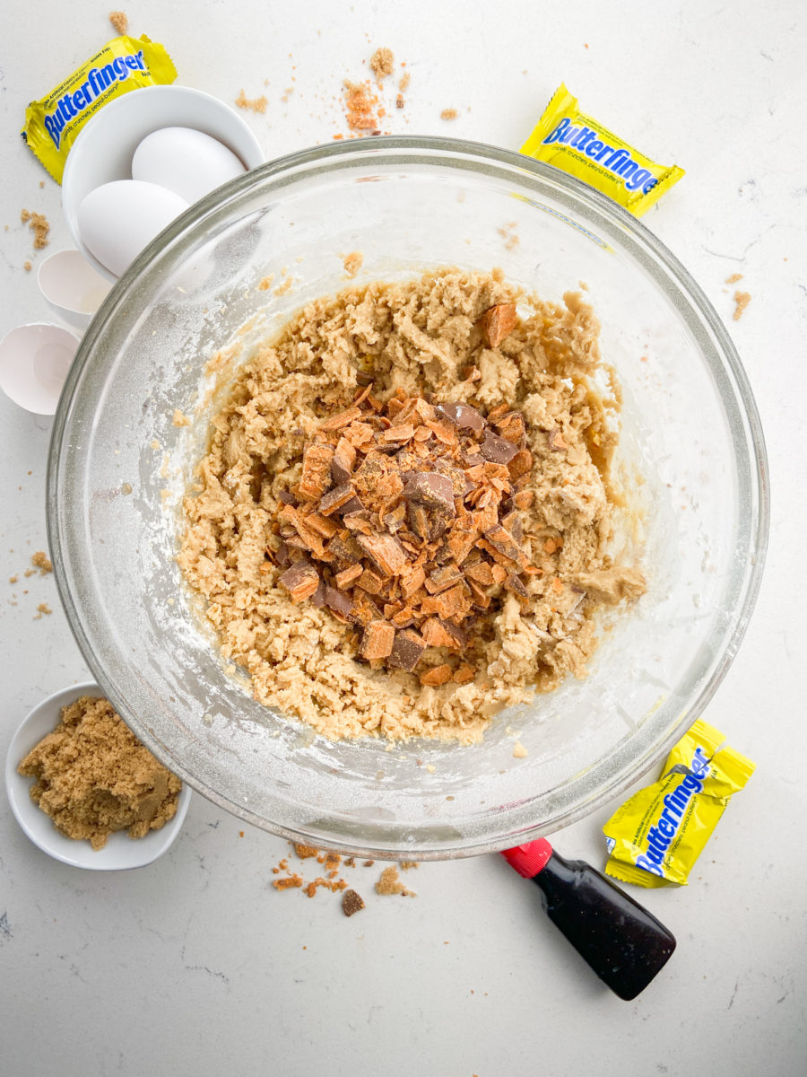 Butterfinger cookie dough in glass bowl. 