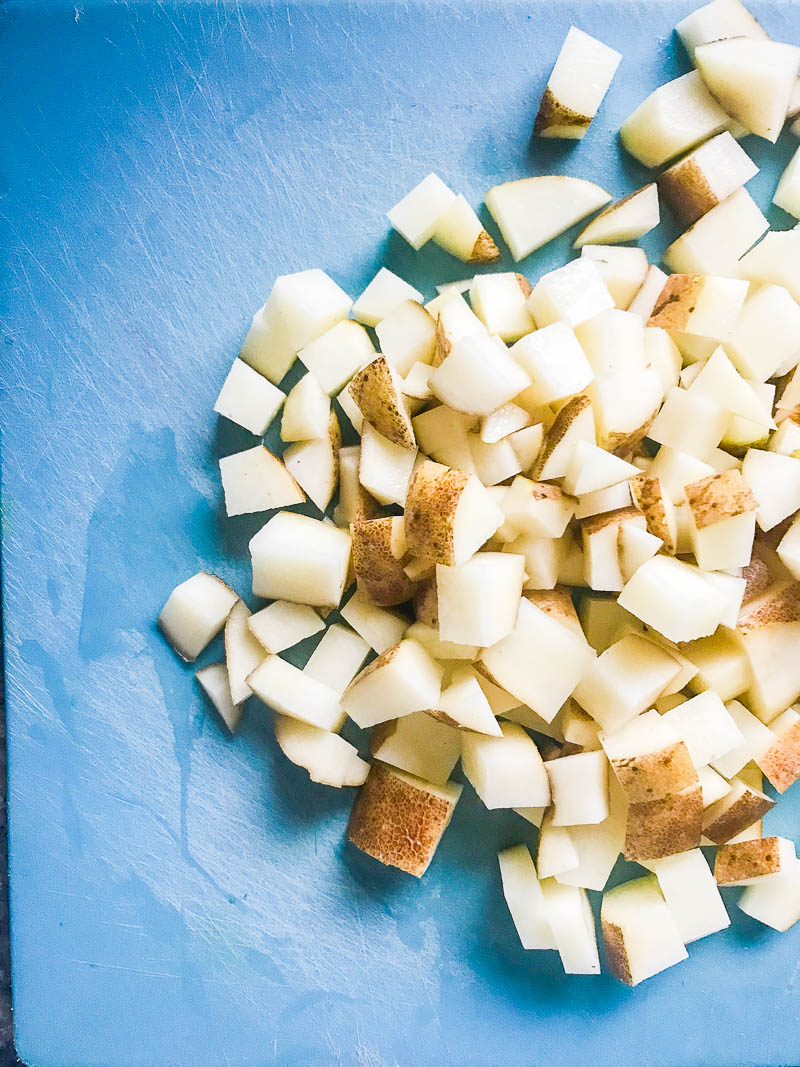 diced potatoes on a cutting board. 