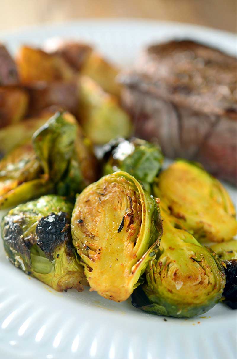 Crispy cajun roasted brussels sprouts are a perfect way to spice up your holiday menu.
