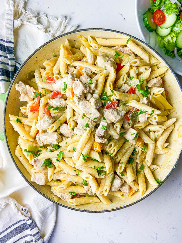 Rasta pasta in a pan on a white background. 